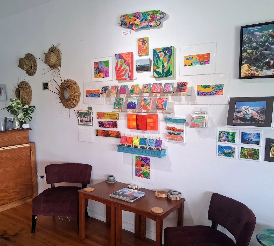 A wall of small paintings by Big Island artists
