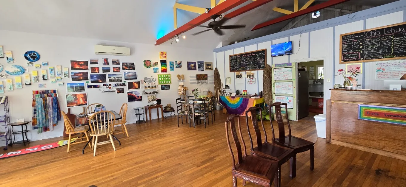 Inside the Ōhi'a Lehua café — art-filled walls, wooden floors, hand-lettered menus